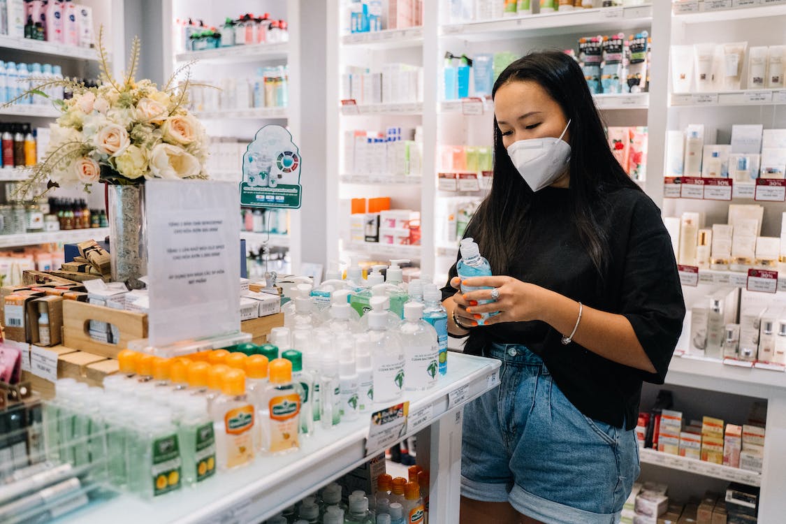 Woman wearing a mask at a pharmacy looking at items