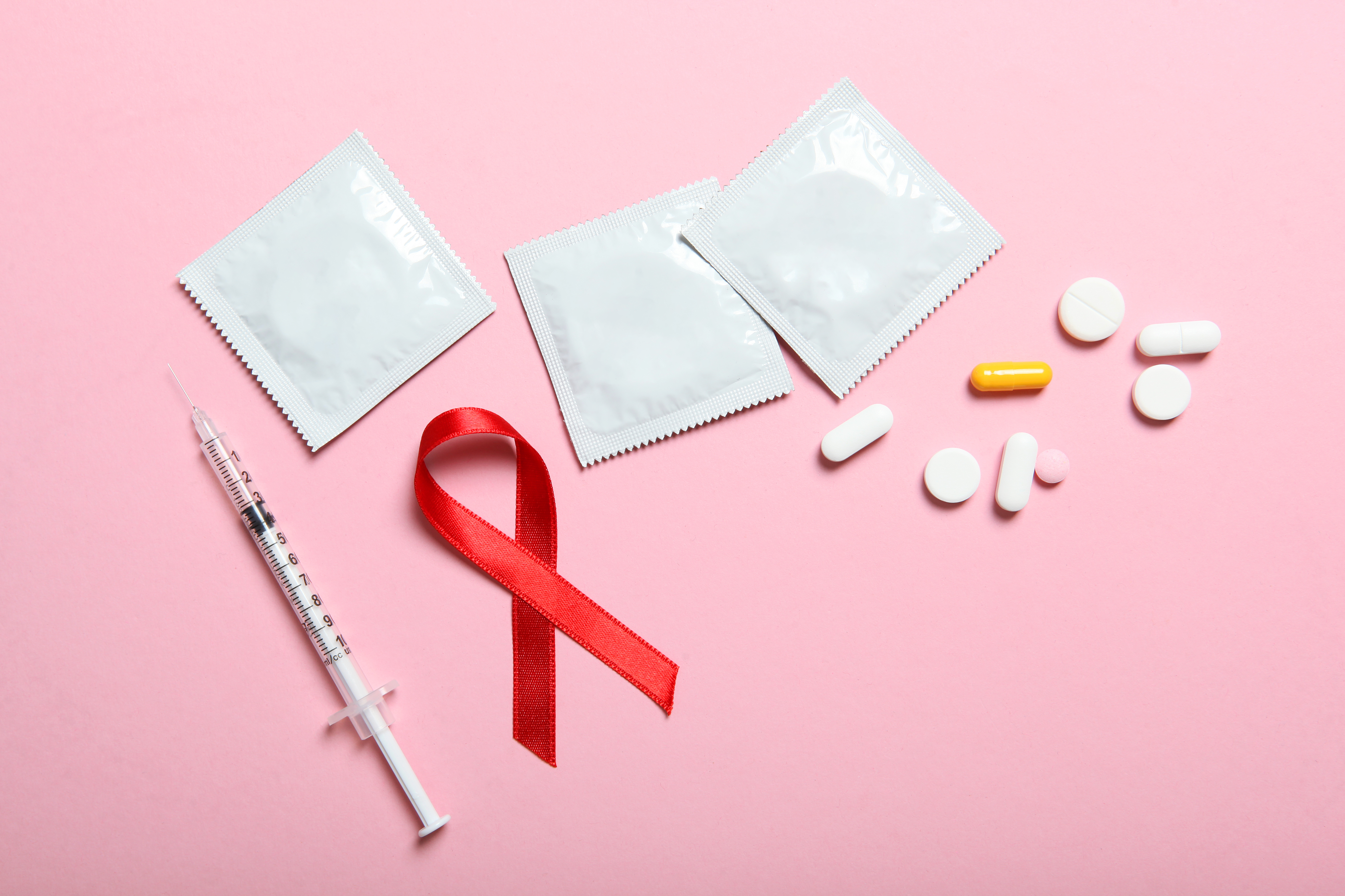 Image showing an injection, HIV day ribbon, condoms and medication
