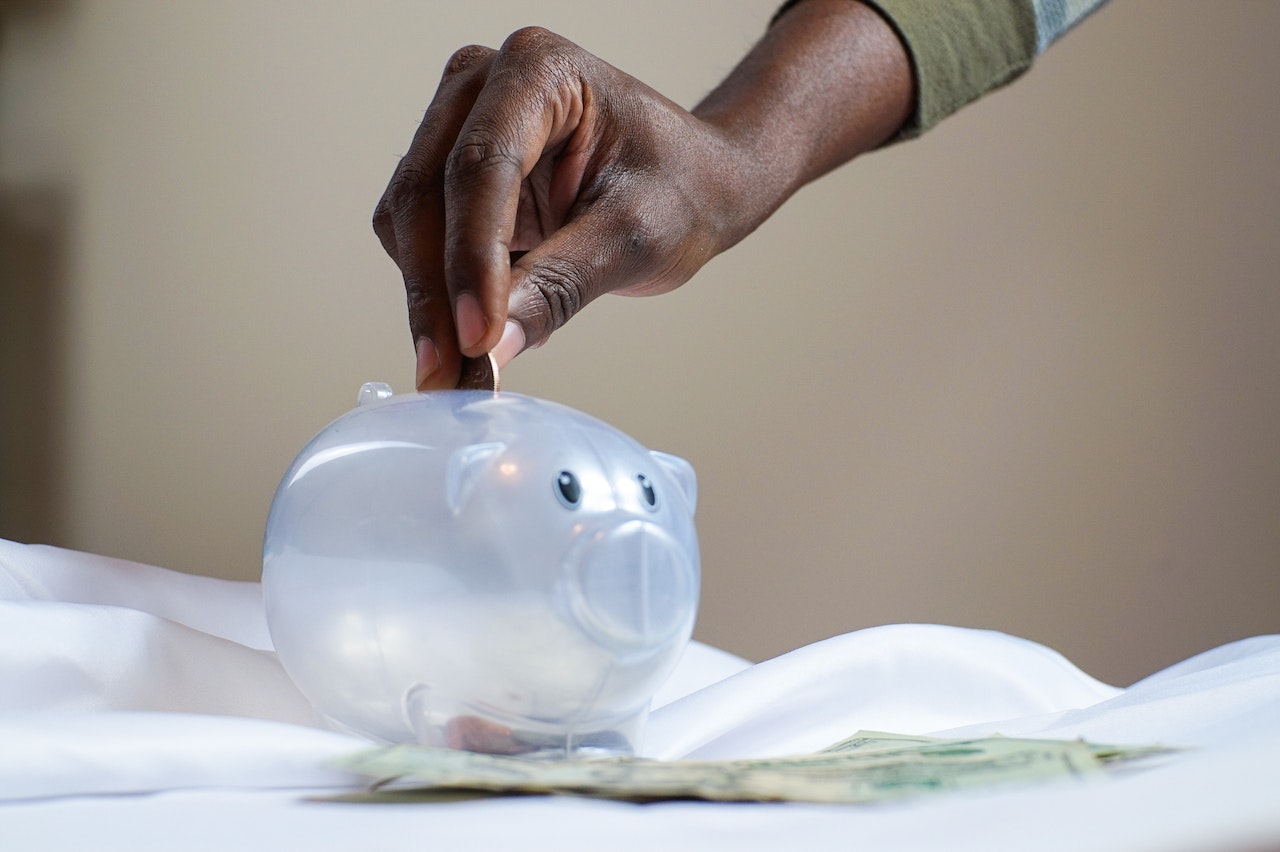 Man putting money into a piggy bank