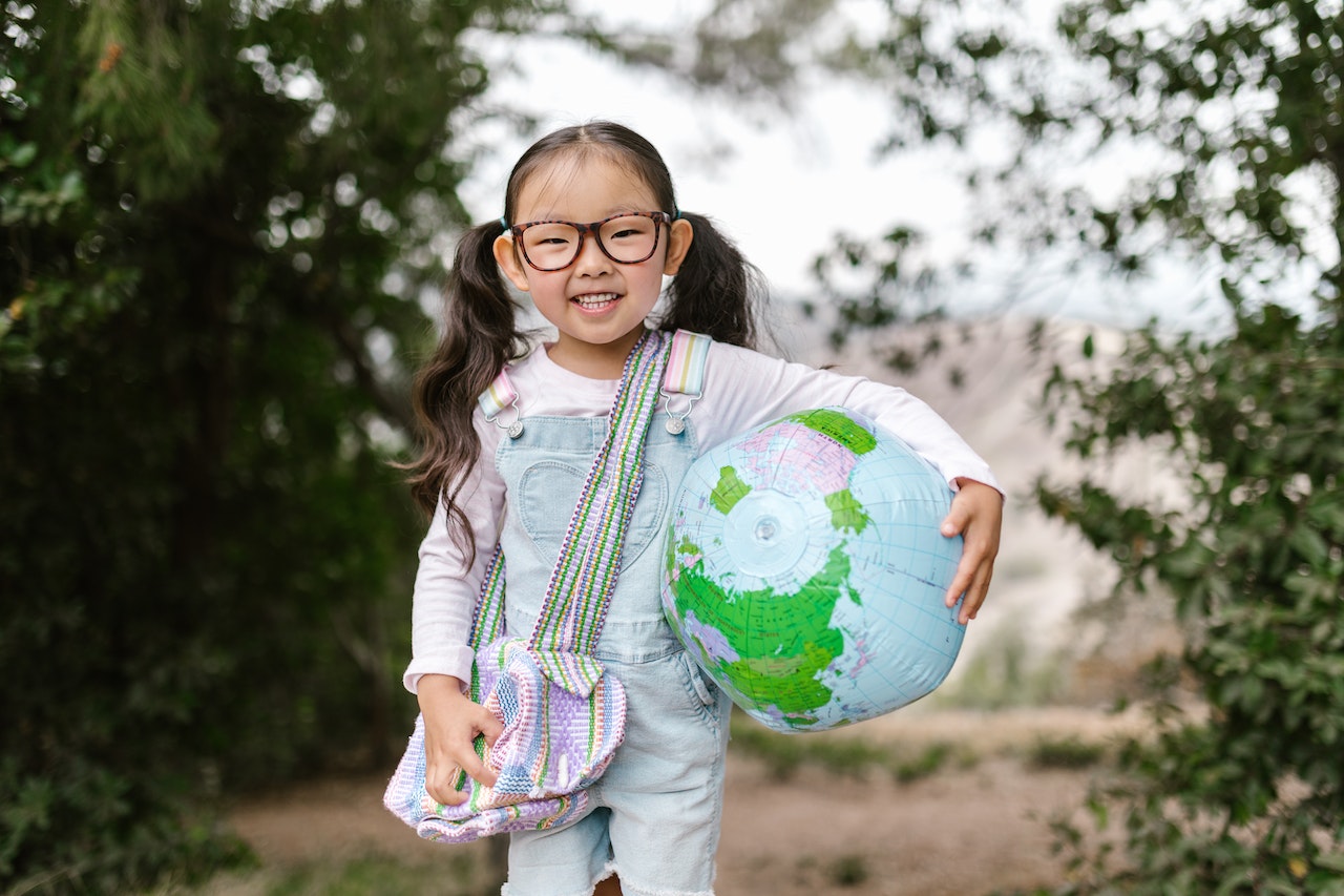 Girl holding a ball that looks like a globe