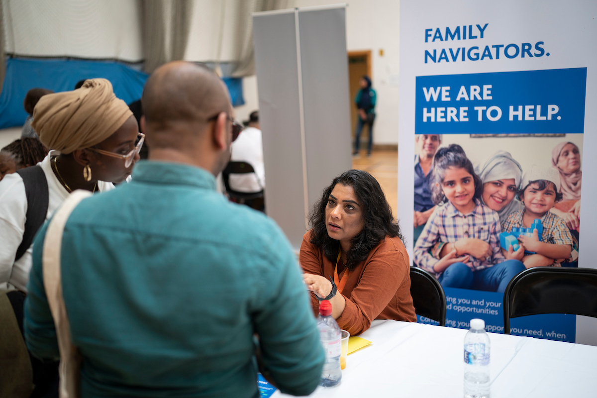 Residents speaking to a Family Navigator at a community event