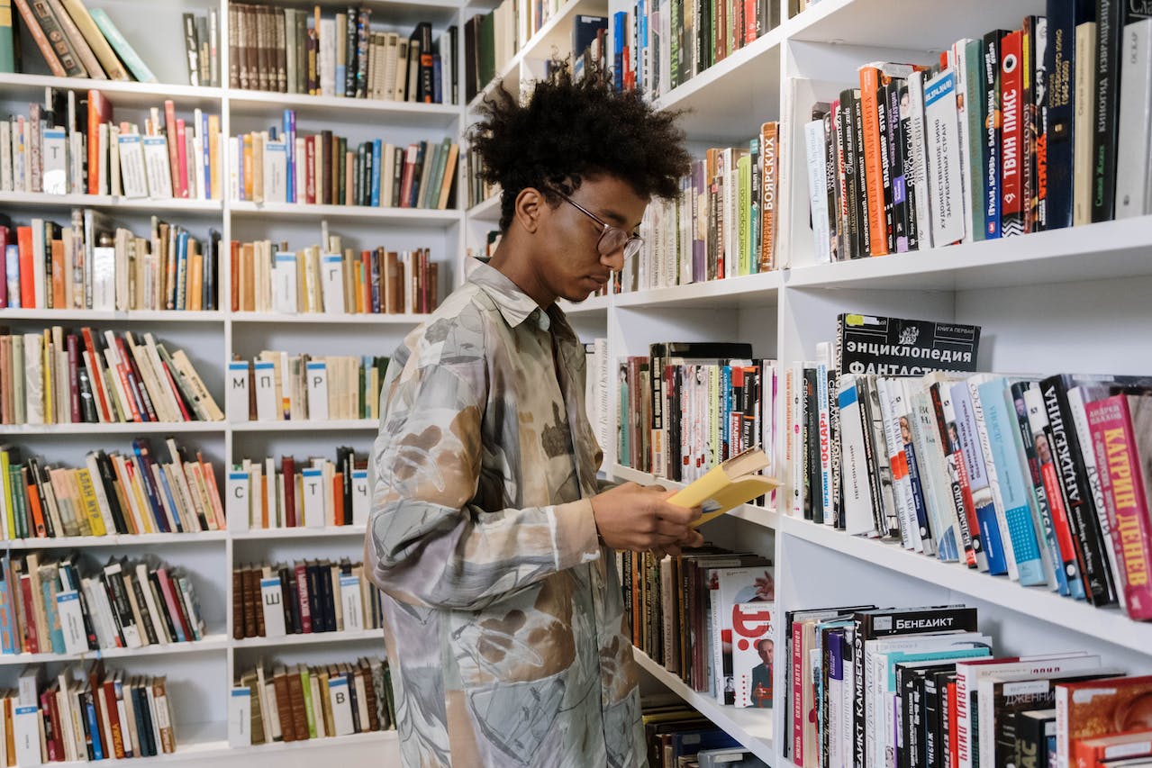 Boy looking at books in a library