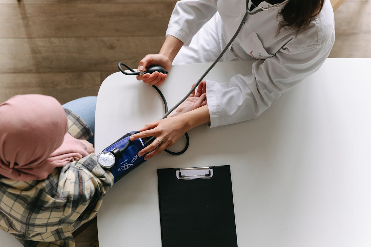 A female doctor checking a patients blood pressure