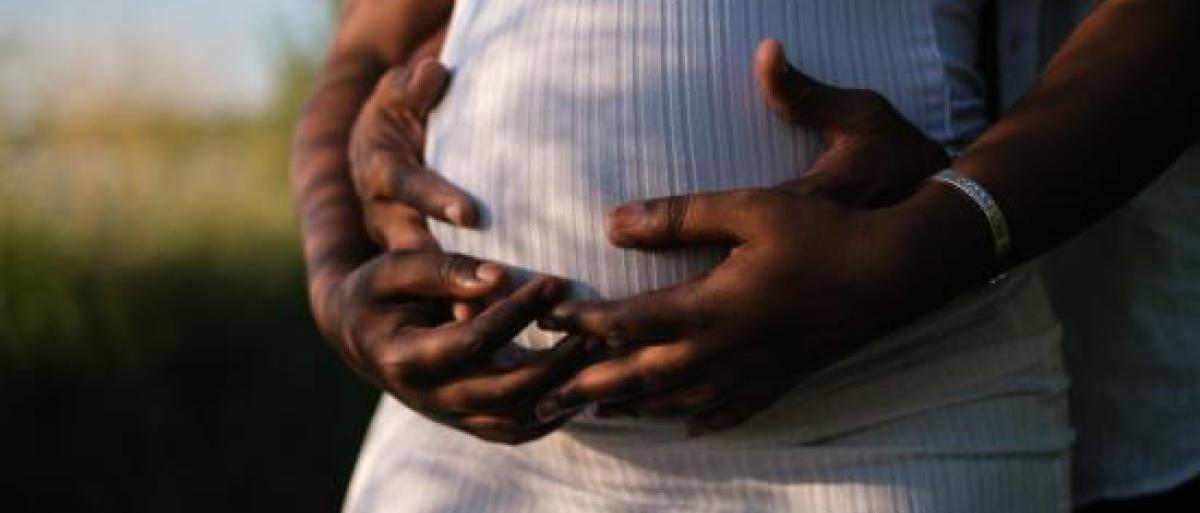 Pregnant woman holding her bump