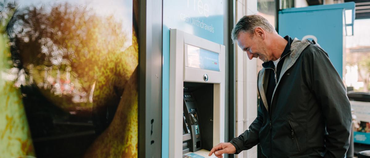 Man getting money out of an ATM