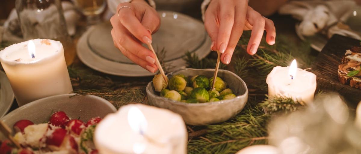 Someon picking from an olive plate