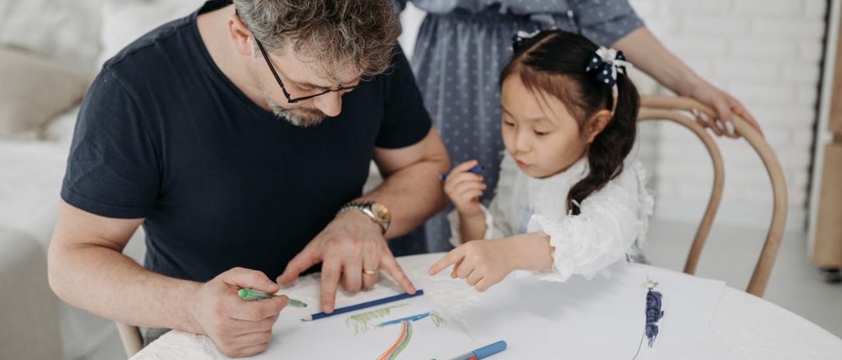 A child and father drawing and painting