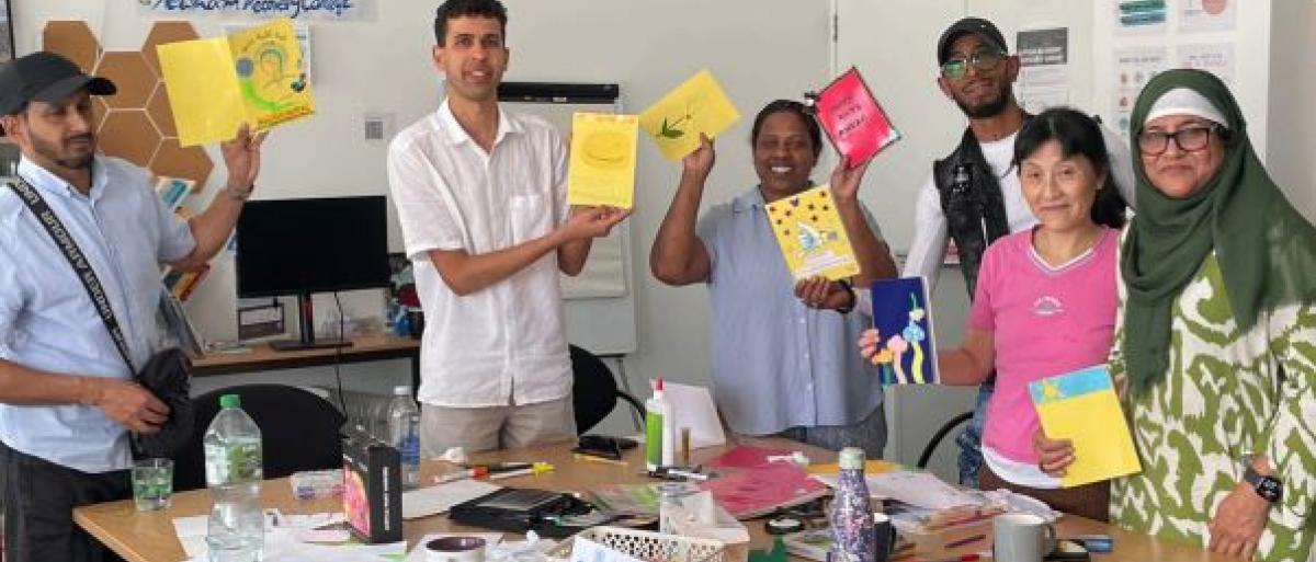 Residents holding cards they designed 