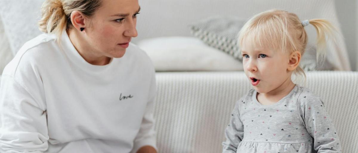 An adult and a child playing with a musical instrument