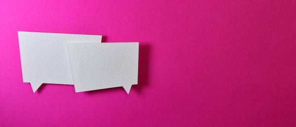 Two white speech bubbles on a vibrant pink background