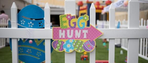 Sign saying Easter egg hunt in front of a children's play area