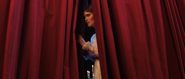 An actress behind a backdrop