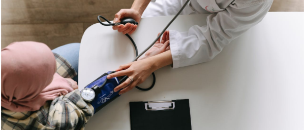 A woman getting her blood pressure checked