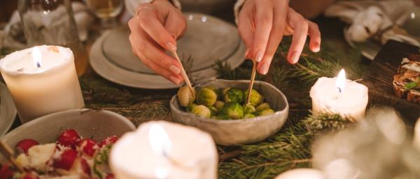 Someon picking from an olive plate