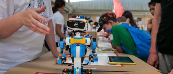 A child holding a small robot