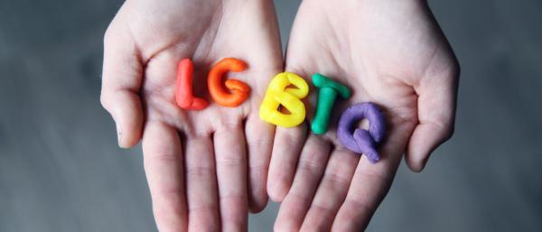 LGBTQ molded with clay on the hand
