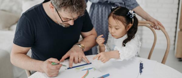A child and father drawing and painting