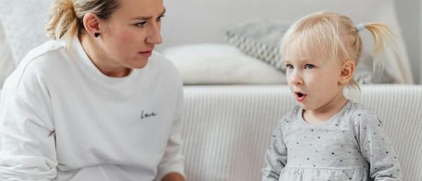 An adult and a child playing with a musical instrument