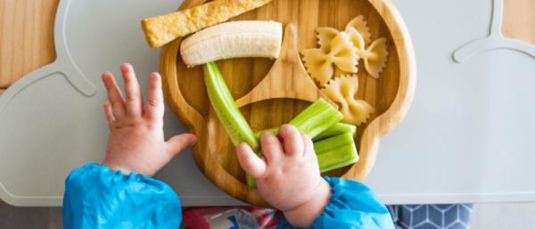 A toddler eating and pictures of healthy snacks 