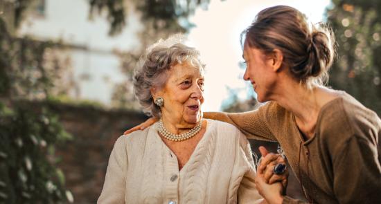 Elderly mother and middle aged daughter talking