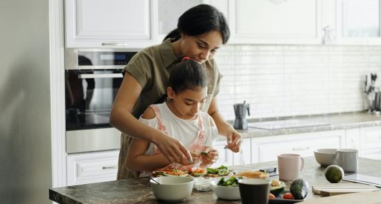 Mum and daughter preparing food together in the kitchen