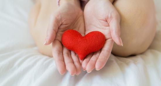 Person holding a fabric heart