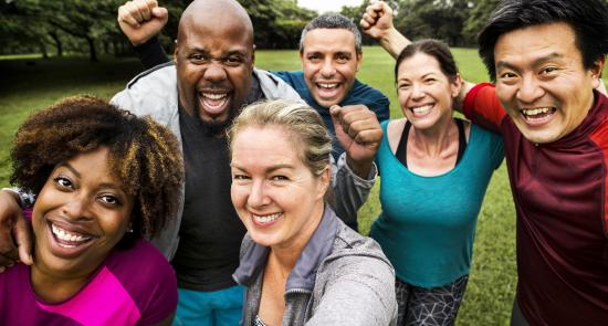 A group of people who have taken a selfie after an exercise call looking happy