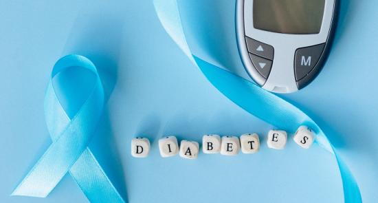 World Diabetes Day image with a blue ribbon, blood sugar monitor and scrabble letters spelling diabetes