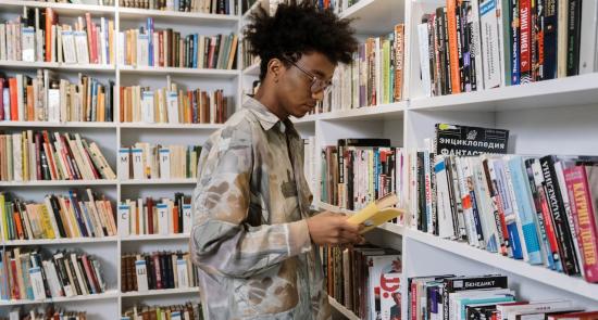 Boy looking at books in a library