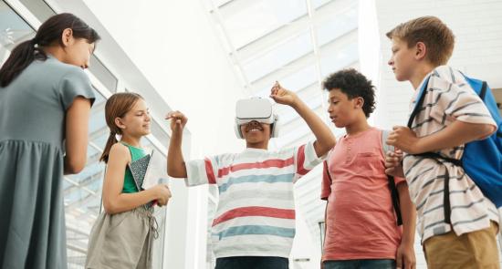 Children playing with a virtual reality headset together