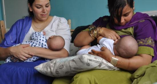 Two mums feeding their babies