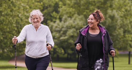 2 women taking a walk through the garden