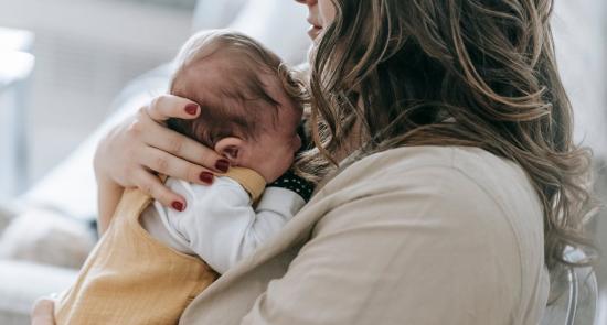 A mother holding a child