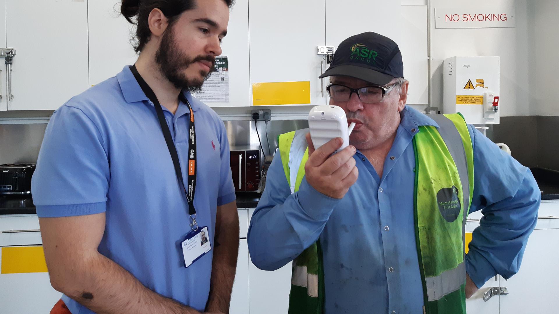 Man doing a breath test as part of a Stoptober event